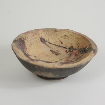 hand built bowl with original poetry fired in a pit.