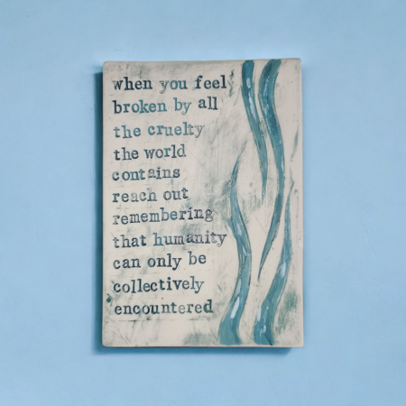 a postcard sized plaque made out of clay, for the wall, with poetry