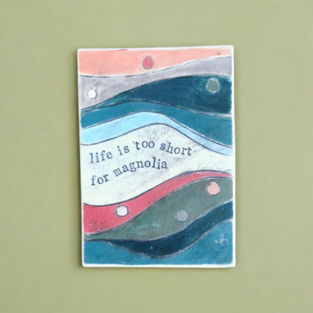 a postcard sized plaque for the wall, made out of clay, with poetry inscribed on it