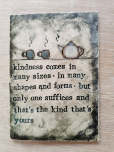 a postcard sized ceramic plaque with poetry